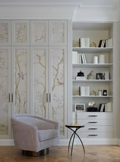 a living room filled with furniture and bookshelves next to a wall mounted book case