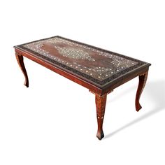 a wooden table with an intricately decorated top