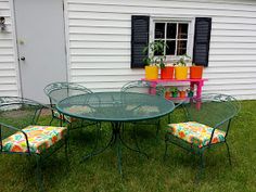 an outdoor table and chairs in the grass