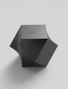 a black and silver object on a white surface with the number 4 in it's center