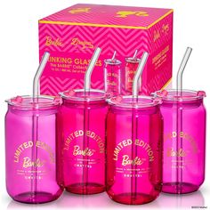 pink glass drinking cups with straws and lids in front of a boxed box on white background