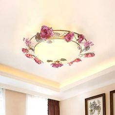 a living room filled with furniture and flowers on the ceiling above it's windows