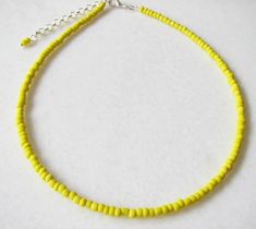 Yellow Choker Necklace Yellow Beaded Choker Dainty Necklace Glass Choker Dainty and elegant all yellow beaded choker with glass tiny seed beads. DESCRIPTION Made from 2mm glass seed beads and closes with a silver plated clasp and 2 inches adjustable chain. SIZE Necklace is 13 inches and can be adjusted up to 15 inches with a 2 inches extender chain. Please let me know if you would like a different length. WRAPPING - All ZafireniaDainty jewelry arrive gift wrapped in a cute bag or box ready for g Yellow Seed Bead Necklace, Yellow Choker, Yellow Beaded Necklace, Yellow Necklace, Seed Bead Necklace, Beaded Choker, Dainty Necklace, Cute Bag, Gold Plated Jewelry