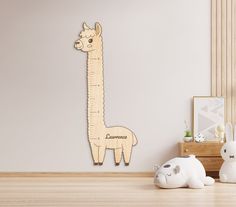 a wooden cut out of a llama next to two small stuffed animals