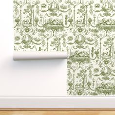 the wall paper is green and white with an ornate design on it, along with a wooden floor