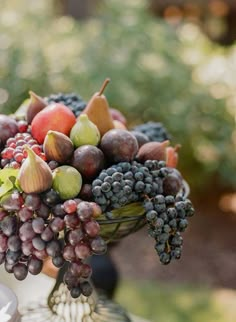 a vase filled with lots of different types of fruit