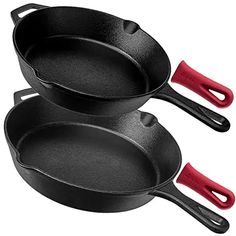 two black frying pans with red handles