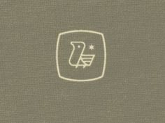 an image of a logo on the back of a book cover that is brown and white