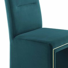 a green chair with gold trim around the legs