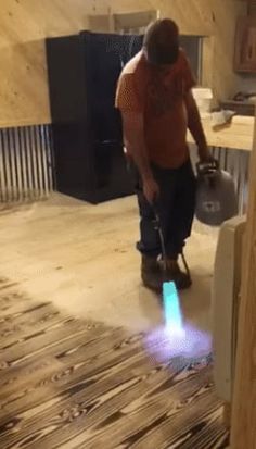 a man is cleaning the floor with a vacuum