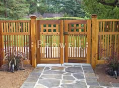 a wooden gate in the middle of a stone walkway