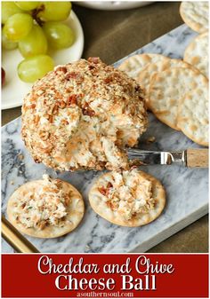 cheese ball with crackers and grapes in the background