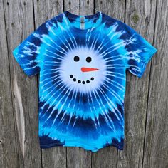 a blue tie - dye shirt with a snowman face on it