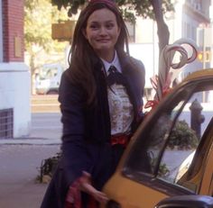 a young woman standing next to a taxi