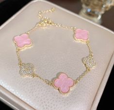 Indulge in the luxury of our Four Leaf Clover Bracelet, crafted with 18k gold plated titanium. This exquisite replica features a delicate pink shell and stunning pave stone design, exuding sophistication and exclusivity. Elevate your style with this elegant and timeless piece. Adjustable Cheap Rose Gold Charm Bracelet, Luxury Pink Diamond Bracelet With 17 Jewels, Stuff You Want For Your Birthday, Cute Things For Birthdays, Luxury Diamond Accented Jewelry For Mother's Day, Luxury Beach Bracelet Jewelry, Pineapple Jewelry Bracelets, Louis Vuitton Flower Bracelet, Elegant Luxury Charm Bracelet With Logo Charm