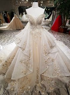 a wedding dress on display at a bridal fashion store in the middle of a room