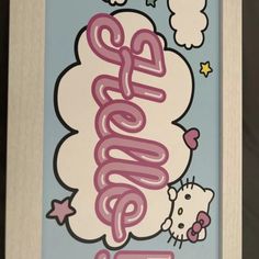 a hello kitty sign is hanging on the wall in front of a window with clouds and stars