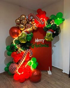 an arch made out of balloons and candy canes with merry grinmas on it