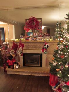 a living room with a christmas tree and fireplace