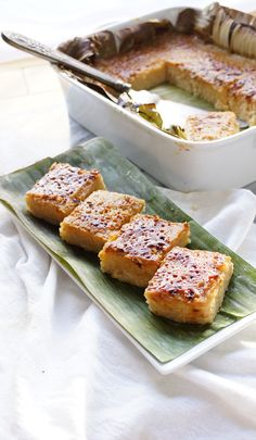 four pieces of cake on a plate with a serving spoon next to it and a casserole dish in the background