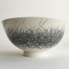 a black and white bowl sitting on top of a table