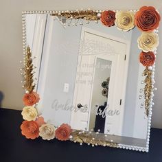 there is a mirror with flowers on it