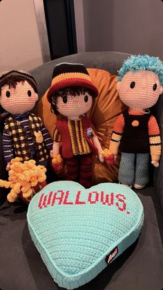 three knitted dolls sitting next to a heart shaped pillow with the word willow's written on it