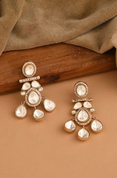 Discover these exquisite Polki dangler earrings featuring an open setting, meticulously crafted from mixed metals and adorned with luxurious 22kt gold plating, exuding sophistication and charm in every sway Finish: 22KT Gold Plating Material: Brass, Polki Color: Gold Size: One Size Closure Type: Push Back Box Contains: 1 Pair of Earrings Luxury Gold Danglers, Heavy Jewellery, Polki Sets, Artificial Jewelry, Polki Earrings, Dangler Earrings, Jewelry Indian, Women's Jewelry And Accessories, Fancy Jewelry