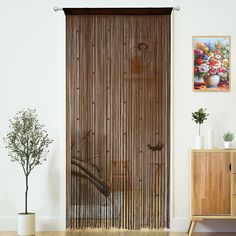 a room with a wooden door and some plants