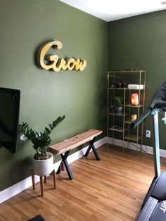 there is a gym room with treadmills and a bench in the corner that says grow