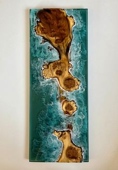 a piece of art that looks like an island in the ocean with rocks on it