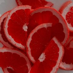 red grapefruit cut in half on white plate