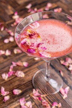 a pink drink with rose petals on the table