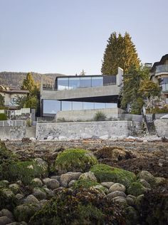 the house is surrounded by rocks and trees