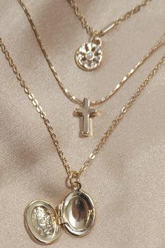 Multi Layer Locket Cross Charm Necklace, this beautifully designed piece features multiple layers of delicate chains, each adorned with unique charms that include a classic locket and a meaningful cross. The layering effect creates a chic, boho inspired look that's perfect for adding depth and dimension to any outfit. Product Details:length: 15", 16", 17"charm: 0.5" locketext: 2"clasp: Lobster Claw, Togglemetal finish: Gold Platedproduct: Lead & Nickel Compliantanti-tarnish: Double E-coating Multi Charm Necklace, Layer Necklace Gold, Multiple Necklaces, Cross Charm Necklace, Sunglass Chain, Layer Necklace, Square Pendant, Gold Necklace Layered, Gold Necklaces