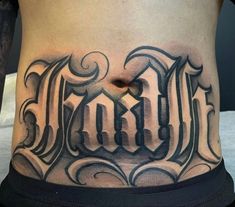 a man's lower back with the word tattoo on his stomach and bottom part