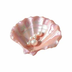 a pink shell with two pearls on it