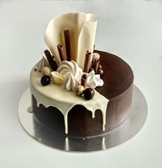 a chocolate cake with white icing and toppings