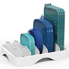 the dish rack is filled with plates and dishes in blue, green, and white