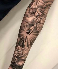 a man with a black and white tattoo on his arm is holding onto a rose