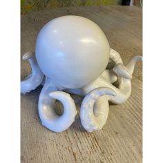 an octopus figurine sitting on top of a wooden table