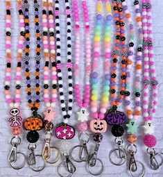 many different colored beads and key chains hanging on a wall