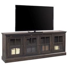 a flat screen tv sitting on top of a wooden entertainment center