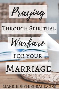 the words praying through spiritual warfare for your marriage on top of a wooden table