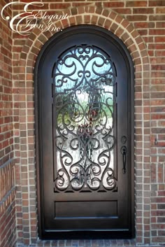 an ornate iron door is shown in front of a brick wall with a glass window