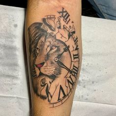 a man's arm with a clock and a lion tattoo on it, which reads time to kill the lions