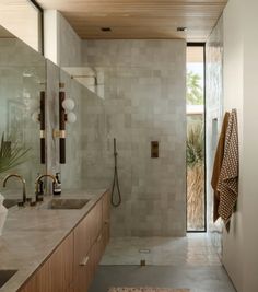 a bathroom with two sinks and a shower