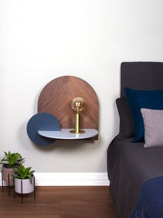 a bed room with a neatly made bed and a shelf on the wall above it