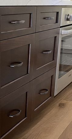 a kitchen with an oven, sink and counter top in the middle of it's wood flooring