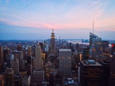 an aerial view of new york city at dusk with the empire building in the foreground